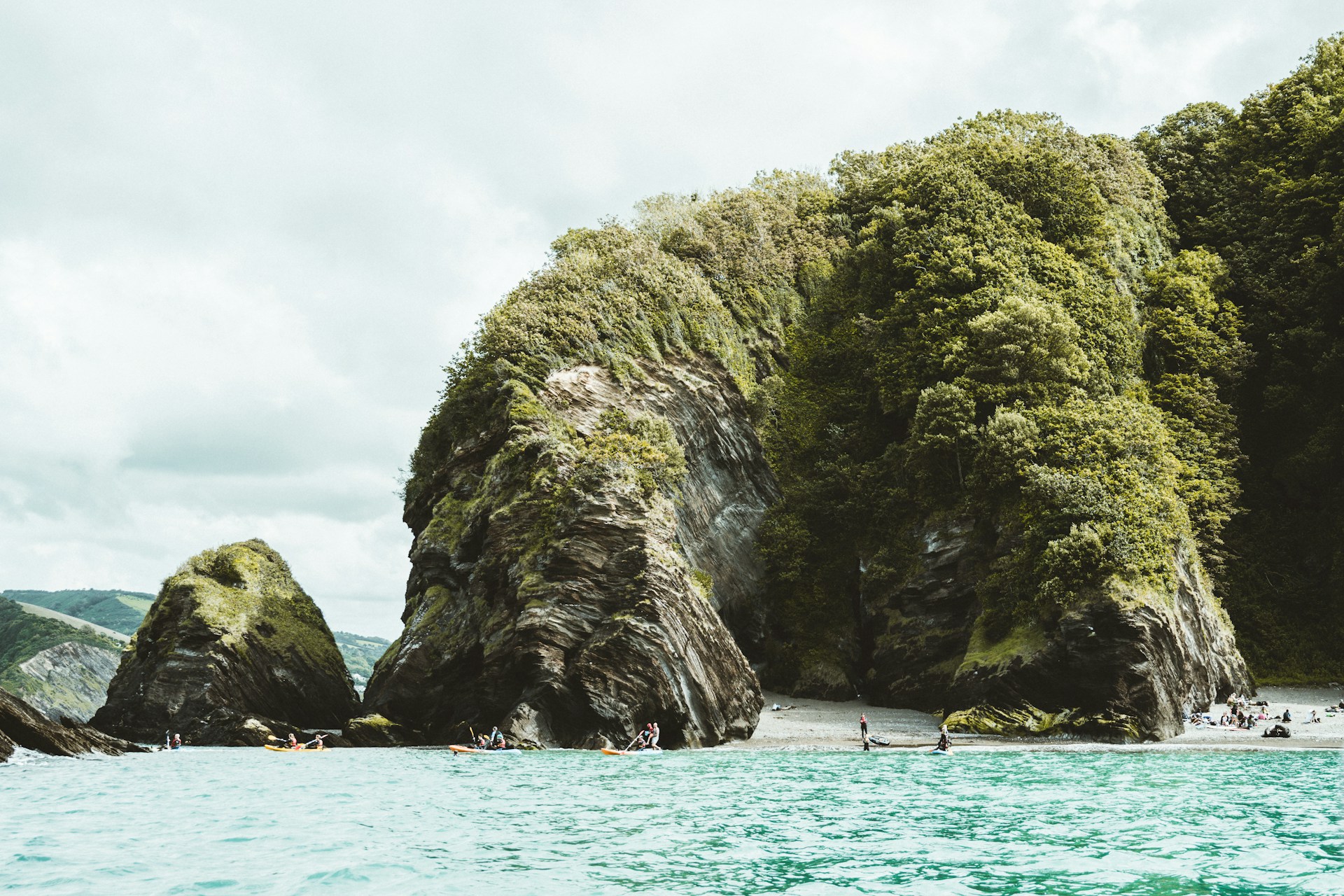 green-and-gray-rock-formation-on-body-of-water