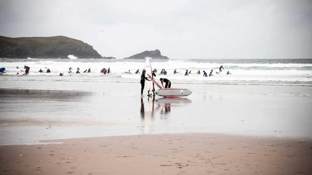 surfers in cornwall beach