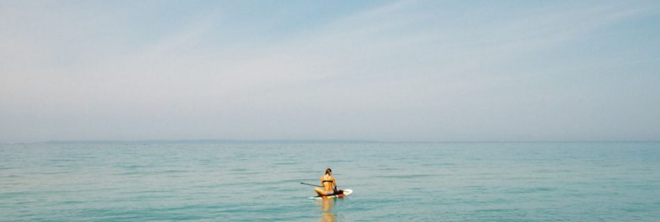 Paddleboard - person in middle of body of water during daytime