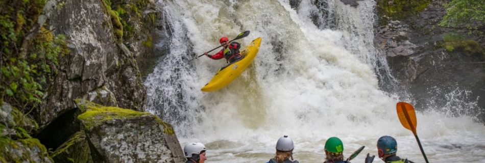 Kayaking - a group of people riding kayaks on top of a river