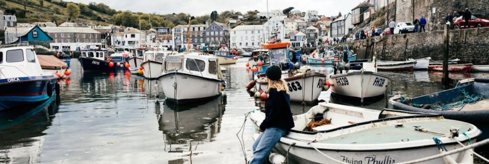 Boat Cornwall - A Woman Sitting on White Boat