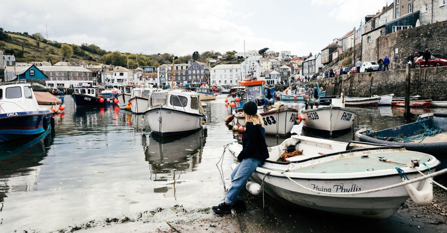 Boat Cornwall - A Woman Sitting on White Boat