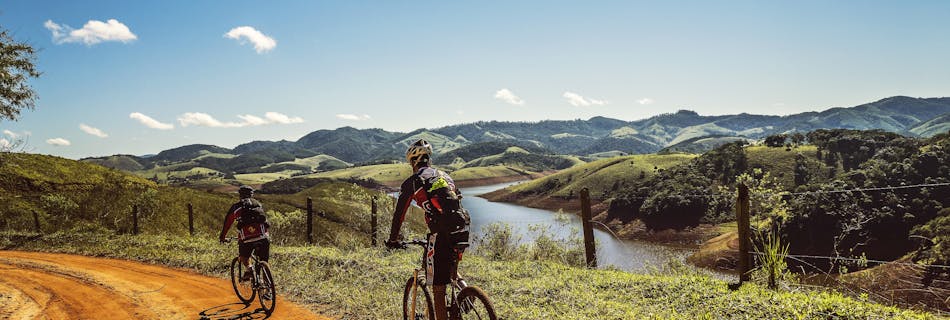 Bicyclist Passing the Road Near the River