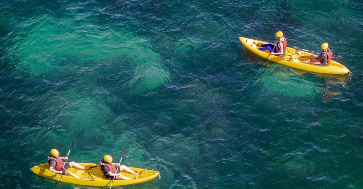 Kayaking Routes - Kayaking in the ocean with a group of people