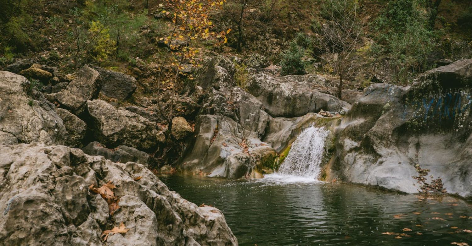 Rock Pooling - Waterfall Between Rocks Pooling into Lake