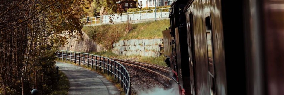 Trip To Cornwall - A train is traveling down a track with smoke coming out of it