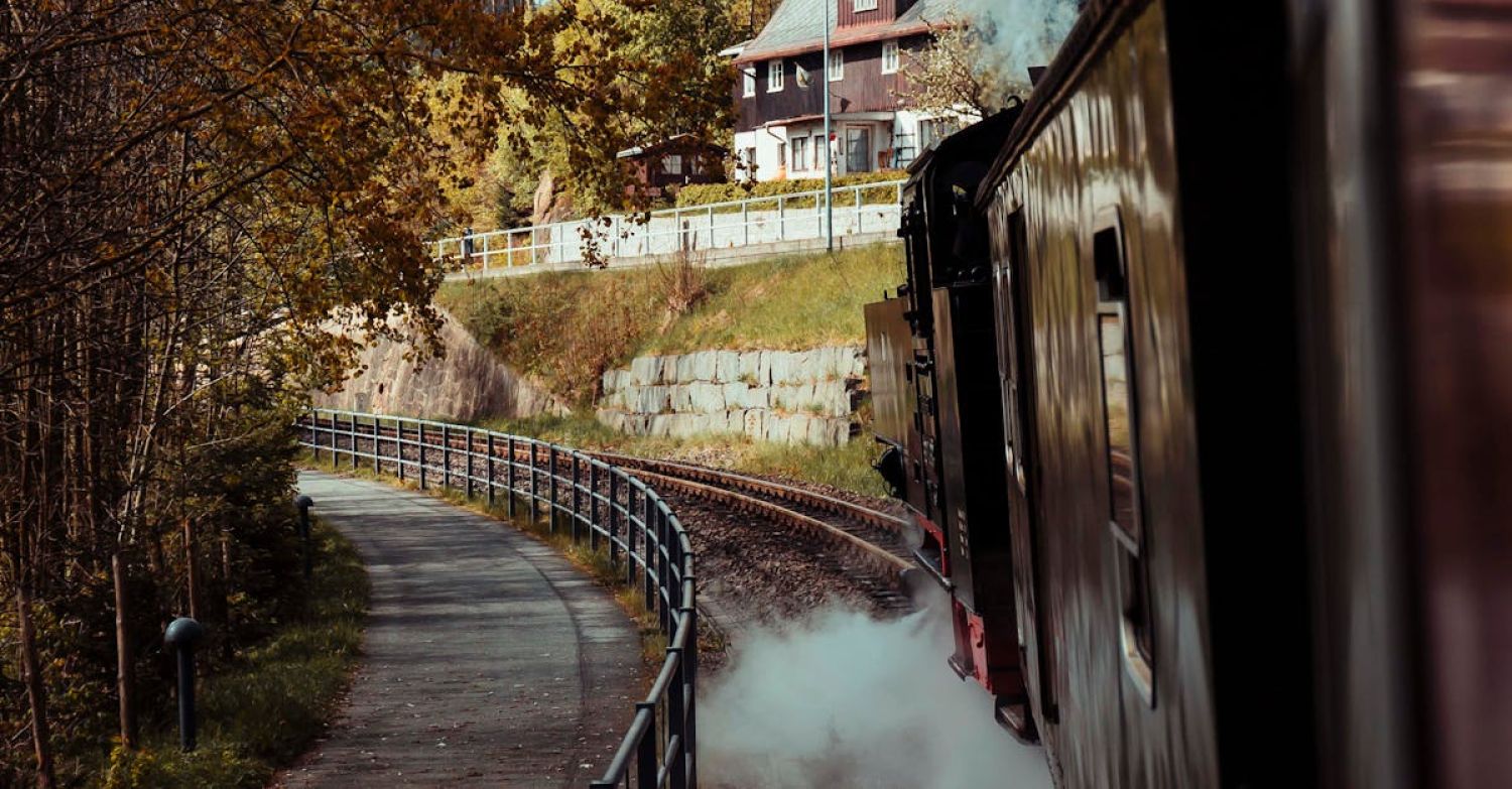 Trip To Cornwall - A train is traveling down a track with smoke coming out of it